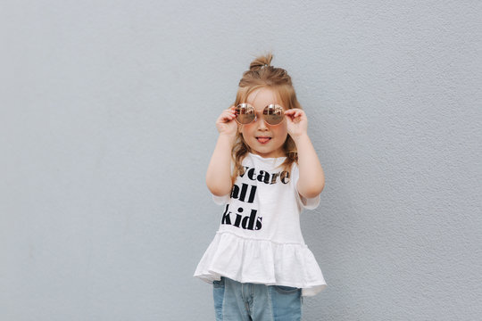 Little Girl Try On Sunglasses And Posing To Photographer