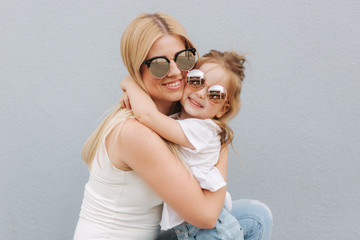 Happy mother and her little daughter in the summer day