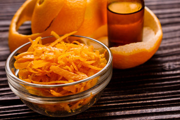 orange essential oil on a wooden background