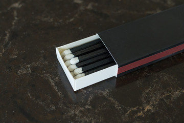 Box of matches against a dark background