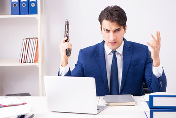 Young handsome businessman employee working in office at desk