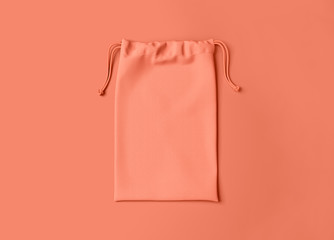 Drawstring bag on background. Fabric cotton small bag. Isolated pouch.