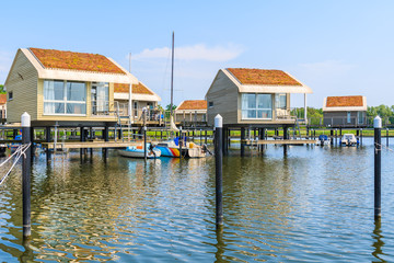 Fototapeta na wymiar Holiday houses on water in Lauterbach port, Ruegen island, Baltic Sea, Germany