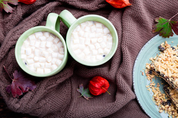 Two cup of coffee or hot chocolate with marshmallow near knitted blanket. Autumn concept. Christmas. Top view.