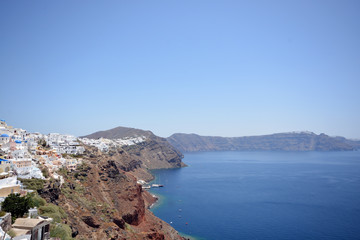 Naklejka na ściany i meble Panoramic view, Santorini island, Traditional and famous white houses and churches with blue domes over the Caldera, Aegean sea.
