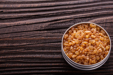 frankincense essential oil on a wooden background