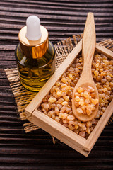 frankincense essential oil on a wooden background