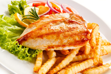 Grilled chicken fillet, chips and vegetable salad