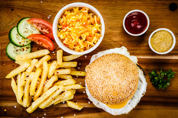 Tasty burger with chips served on cutting board