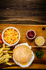 Tasty burger with chips served on cutting board