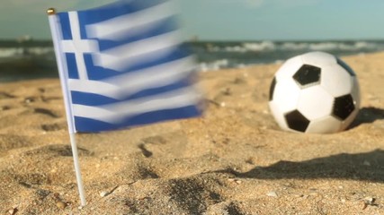 Sandy beach, football ball and the flag of Greece. - Powered by Adobe