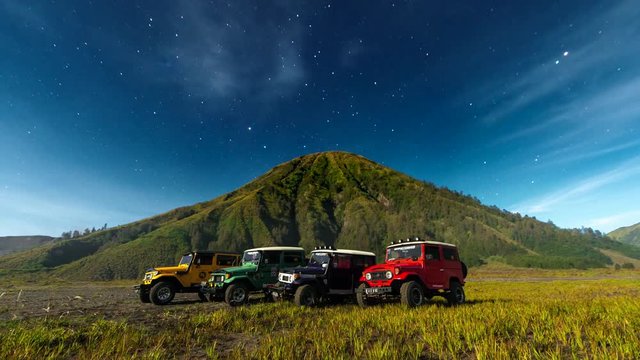 4K Timelapse Moving Star Night Scene with Jeeps around of Mts. Bromo, Semeru, Batok and Widodaren, Tengger Caldera, Indonesia