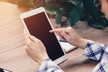 Asia woman using tablet on table in coffee shop