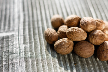 aromatic nutmeg on a gray wooden background