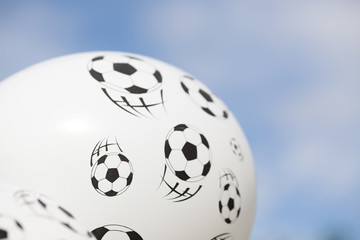 balloon with footballs against blue sky - soccer supporter - world cup