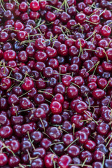 Cherries at a market. Top view of fresh ripe cherries background. Red cherry background