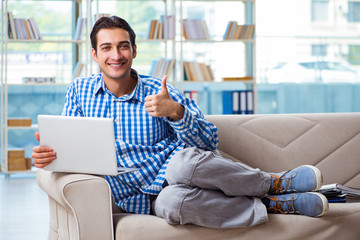 Caucasian student with laptop preparing for university exams