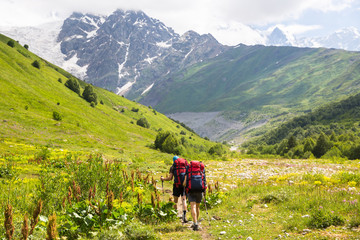 Fototapeta na wymiar Hiking in beautiful mountains. Group of hikers enjoy sunny weather