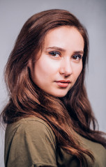 Fototapeta premium Close up portrait of beautiful cute brunette woman on grey background. Positive emotions, facial expression