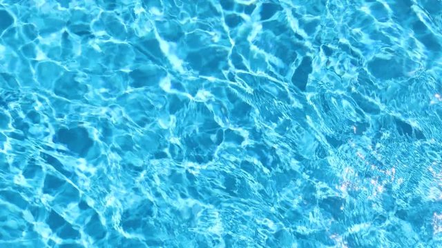 Surface of blue swimming pool, background of water in swimming pool. Slow motion 60 fps