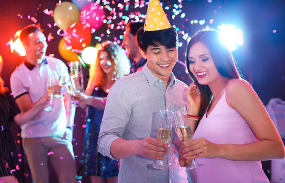 Young people celebrating birthday in nightclub