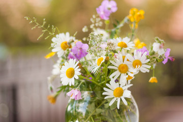 A colorful bouquet of freshly picked wild flowers from a natural meadow and garden. Presented on a...