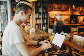 Man working on laptop in creative bar