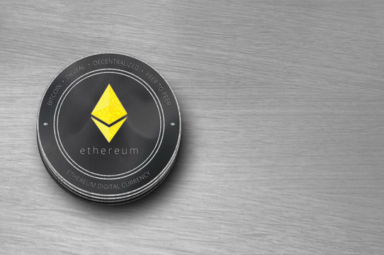 Ethereum (ETH) digital crypto currency. Stack of black and silver ether coins. Cyber money.