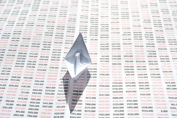 Origami paper white boat on a big sheet of paper with large round numbers filled on it. Front view