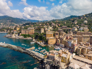 Naklejka premium Aerial View of Camogli town in Liguria, Italy. Scenic Mediterranean riviera coast. Historical Old Town Camogli with colorful houses and sand beach at beautiful coast of Italy.