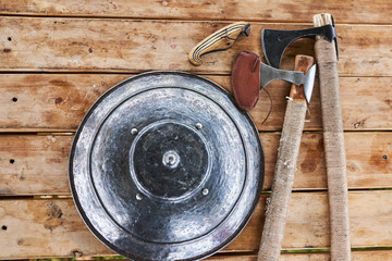 The shield and axe on a wooden table