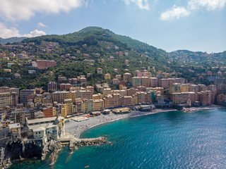 Aerial View of Camogli town in Liguria, Italy. Scenic Mediterranean riviera coast. Historical Old Town Camogli with colorful houses and sand beach at beautiful coast of Italy.