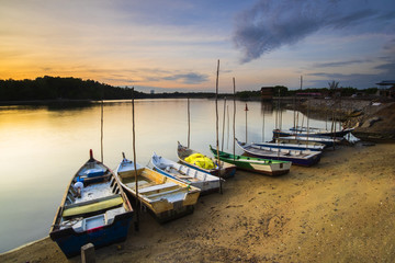Fototapeta na wymiar Sunrise Scenery at Lumut Bay,Perak,Malaysia with Resting Boat. Soft focus,Blur due to Long Exposure.