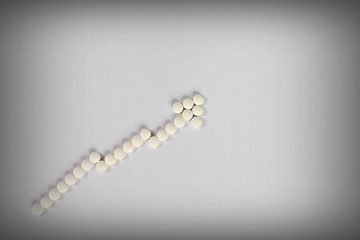 Healthcare, medical or drug abuse concept : Top view or flat lay of rising graph cost of prescription drugs on gray background with copy space