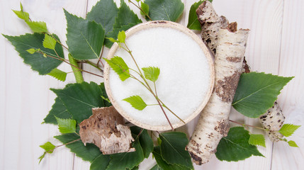 Xylitol - sugar substitute. Birch sugar on white wooden background. - 210527811