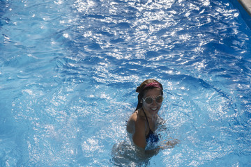 Woman inside the pool enjoying happy