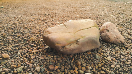 Fototapeta na wymiar gravel stones different shape as floor texture background. Small rocks background texture, abstract stone texture pebbles.