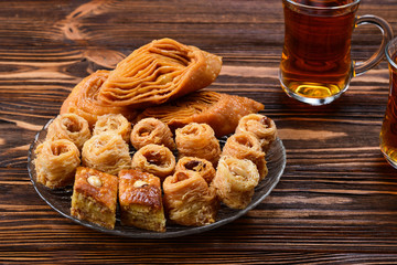 Turkish sweet baklava on plate with Turkish tea.