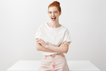 Yeah live on bright side. Portrait of charming carefree redhead female student in pink jeans and...