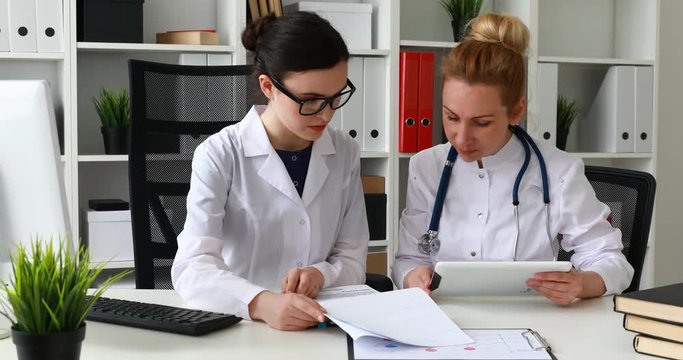doctors comparing data in documents.