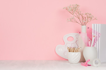 Creativity school background for girl's - white stationery, palette, pencils on soft pink wall and white wood desk.