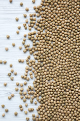 Raw chickpeas on a white wooden background, top view. From above