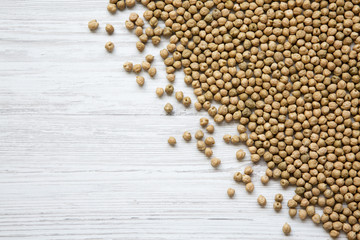 Top view, dried chickpeas on white wooden background. Copy space.