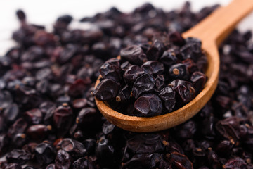 dried barberry berries on the rustic background
