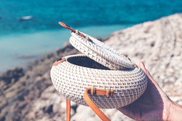 Fashionable stylish rattan bag outside. Tropical island of Bali, Indonesia. Rattan handbag.
