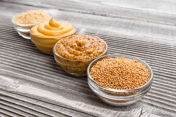 Set of different species of mustard on a rustic background
