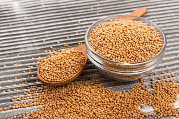 mustard in a bowl on a rustic background