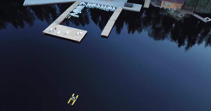 Aerial view of a man who swims on a lake on a pedal catamaran, a water bike 