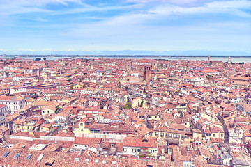 Fototapeta na wymiar View over Venice and its different quarters / Architecture, rooftops and houses of Venice in Italy seen from St. Mark's Tower