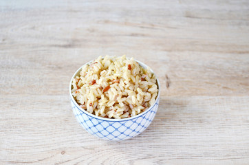 Sprouted brown rice in bowl on wooden background, Asian food style